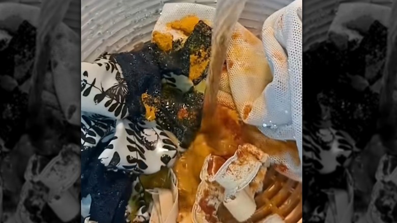 Water poured into a salad spinner with fabric and dye.
