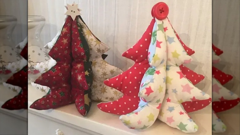 Homemade, stuffed, fabric Christmas trees displayed on a mantel
