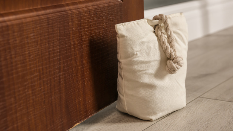A stylish beige doorstop with decorative thick rope detail