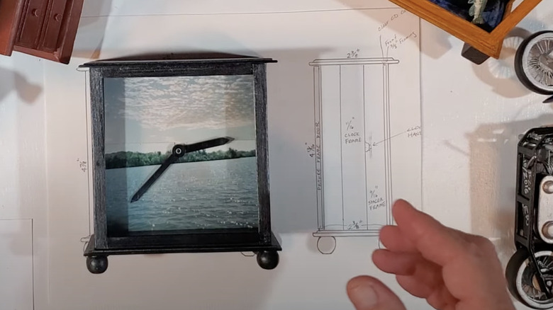 A photo of a lake or ocean landscape is inserted into the background of an old alarm clock.