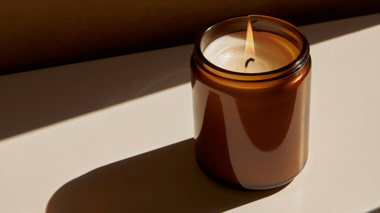 lit candle in amber glass