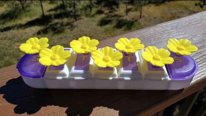 pill organizer repurposed with feeder flowers for hummingbird