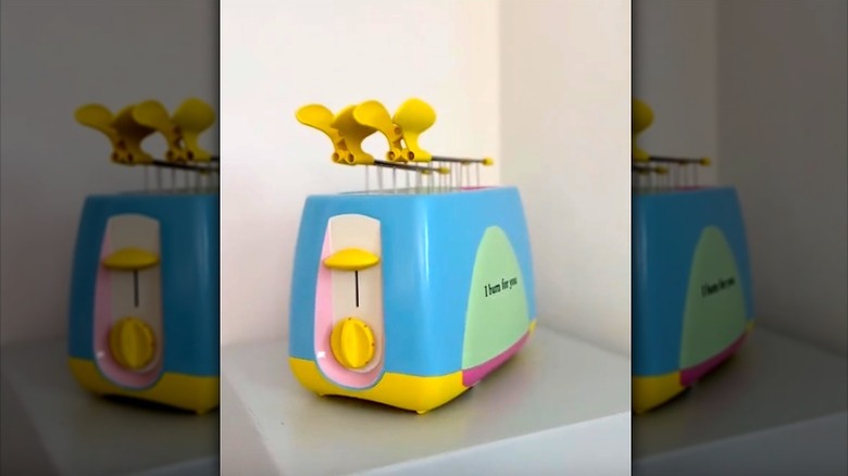 Old toaster painted in pastel colors on corner shelf