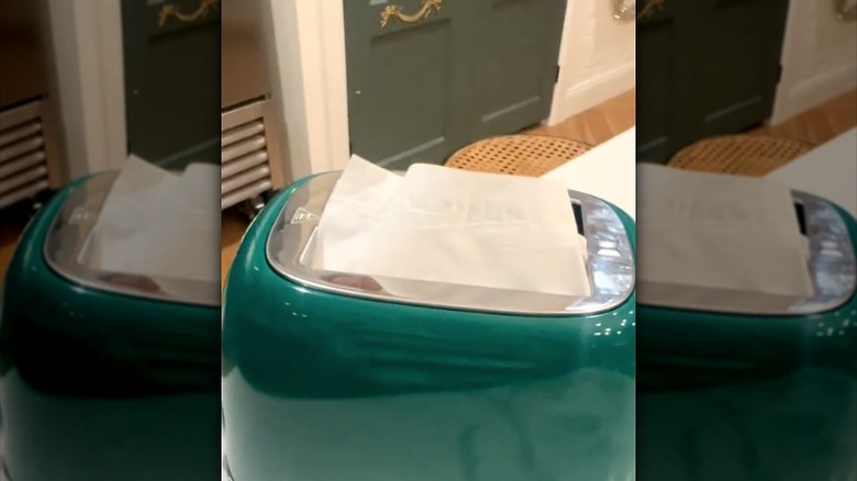 Green toaster holding tissues in slots