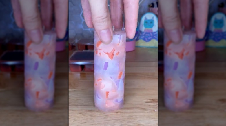 A finished DIY candle made from wax scraps and a toilet paper roll mold.