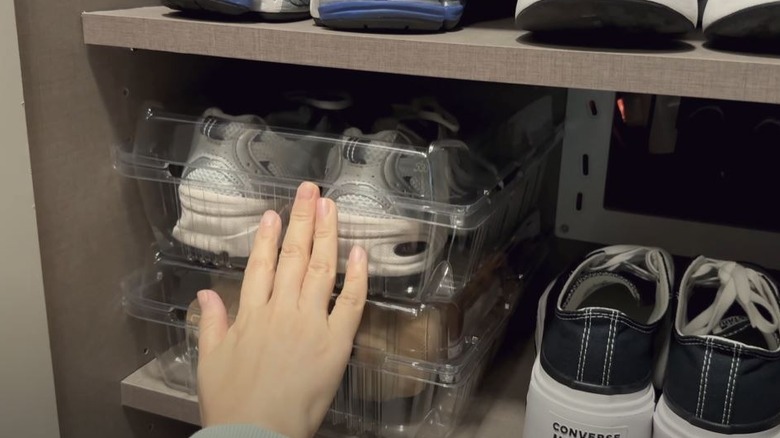 Person using plastic containers for shoe storage