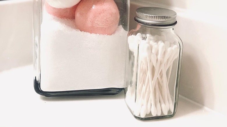 jars with bathroom grooming items on counter