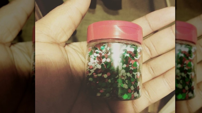 person holding glitter in a spice jar