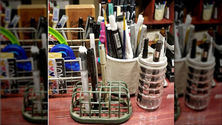spice jar holding pens on desk