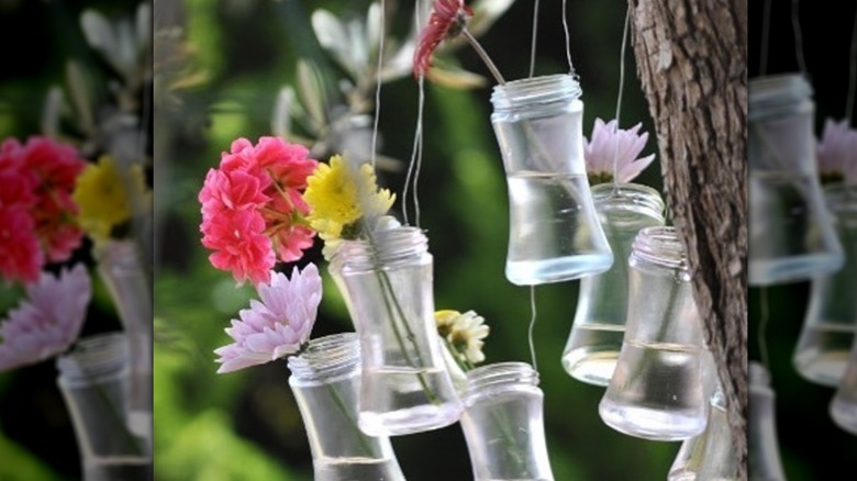 Spice jars suspended from wire with flowers