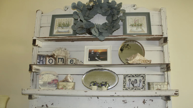 A DIY wall shelf made from the headboard of an old bed frame.