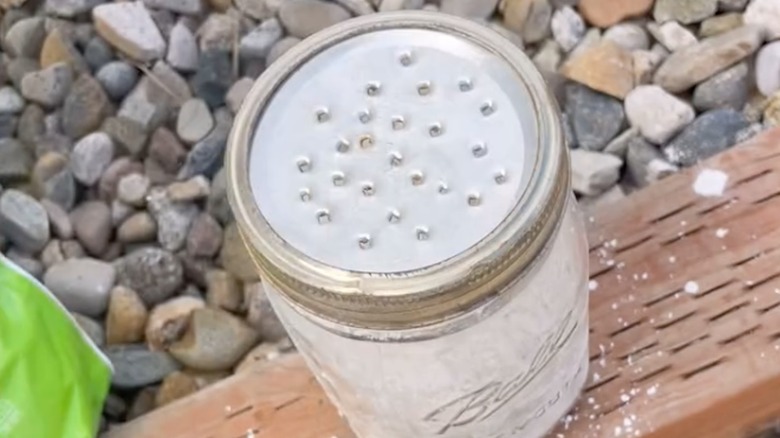A mason jar lid with holes drilled in it.