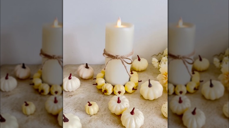 A mason jar lid turned into a pumpkin candle holder.
