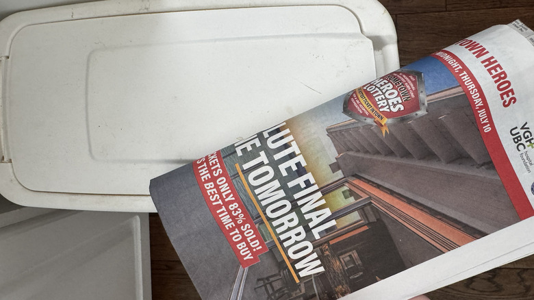 Trash can and newspaper