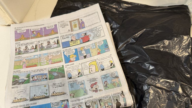 Newspaper and black bin bag