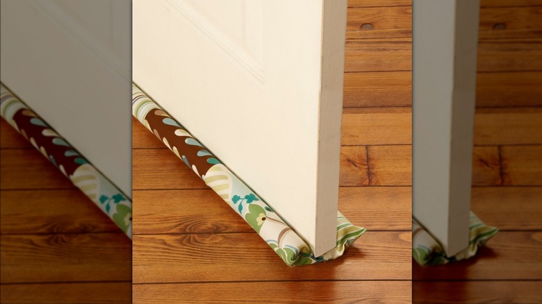 brown and green fabric draft stopper