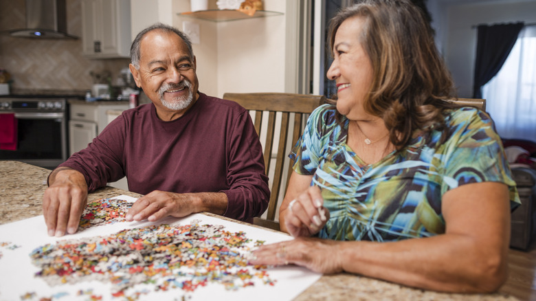 A couple working on a puzzle together