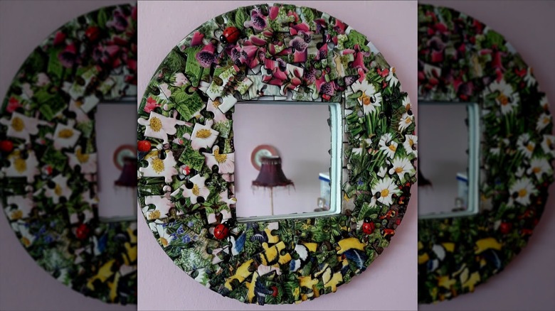 Mirror bordered by puzzle pieces hanging on a wall
