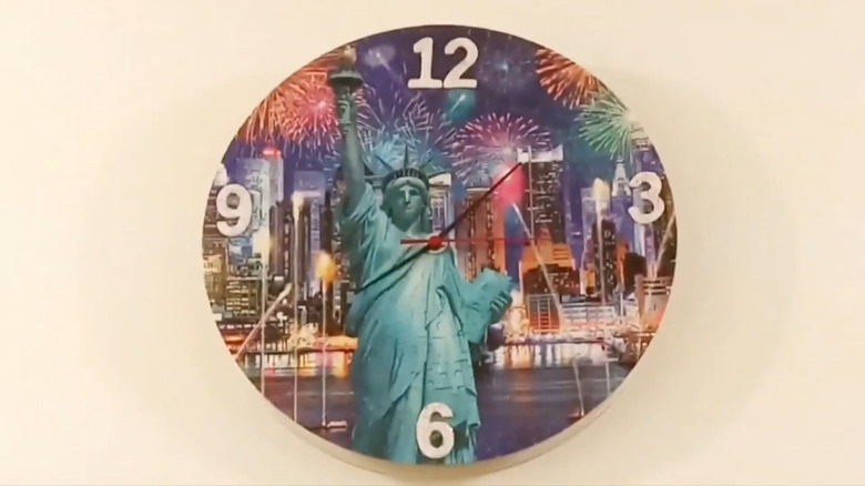 Clock made from patriotic puzzle featuring Statue of Liberty against the background of New York City with fireworks