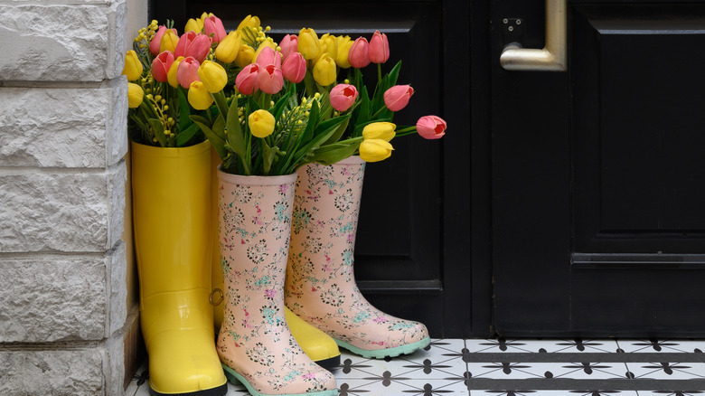 Rainboots being used as decoration by a door