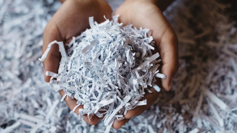 closeup of hands holding shredded paper