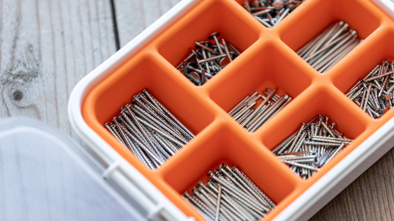 Orange and white box with screws in compartments.
