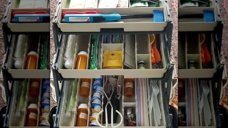 Camp cooking materials in a gray and black tackle box.