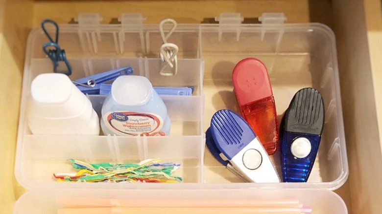 A clear container with compartments in drawer.