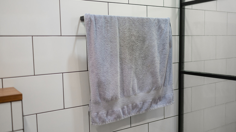 An old towel hanging in the bathroom.