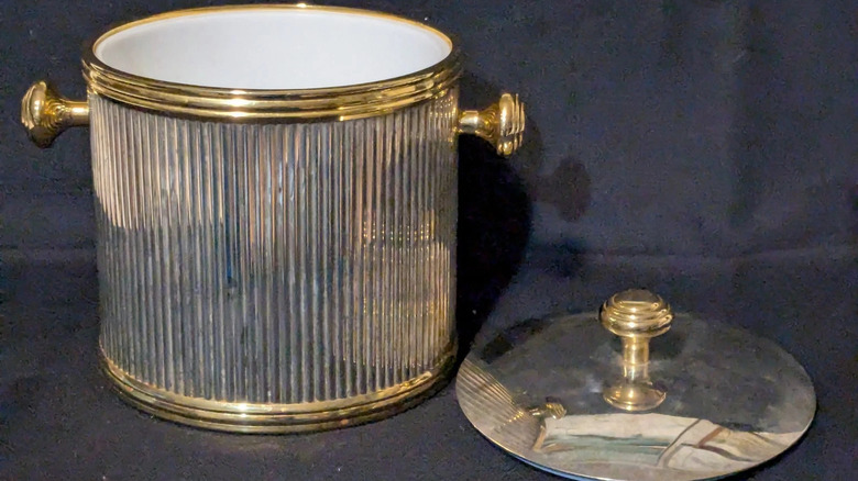 Vintage brass silver plated ice bucket from 1960s on dark background