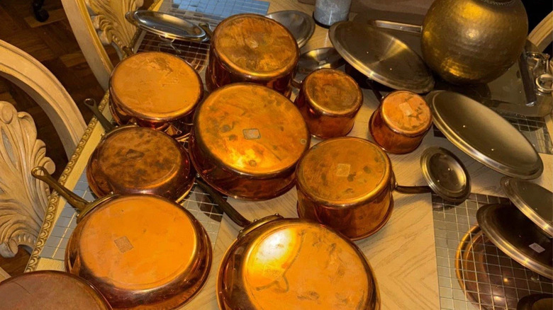 Pile of William Sonoma copper cookware pans upside-down