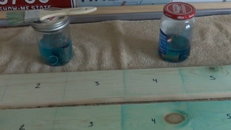 Wood stained in various shades of blue using a DIY copper stain.