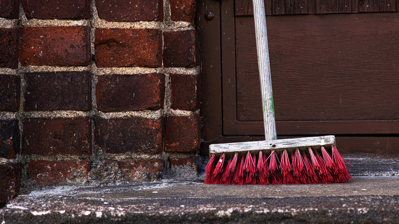 A broom sitting by the front door