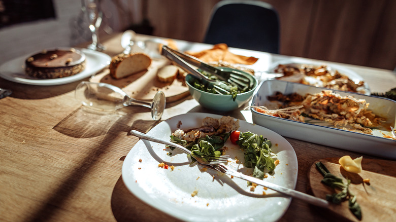 Plate with leftovers after Christmas lunch party at home