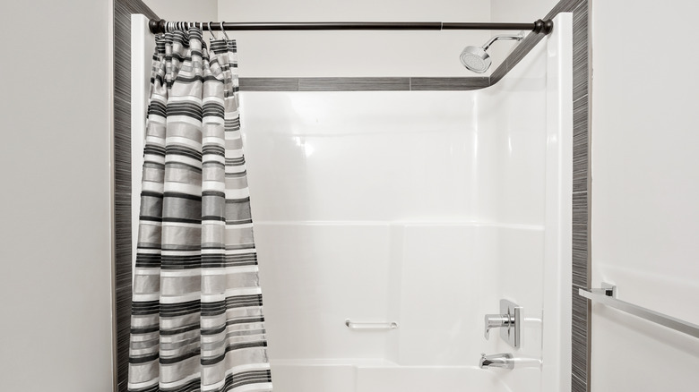 shower with gray and black shower curtain