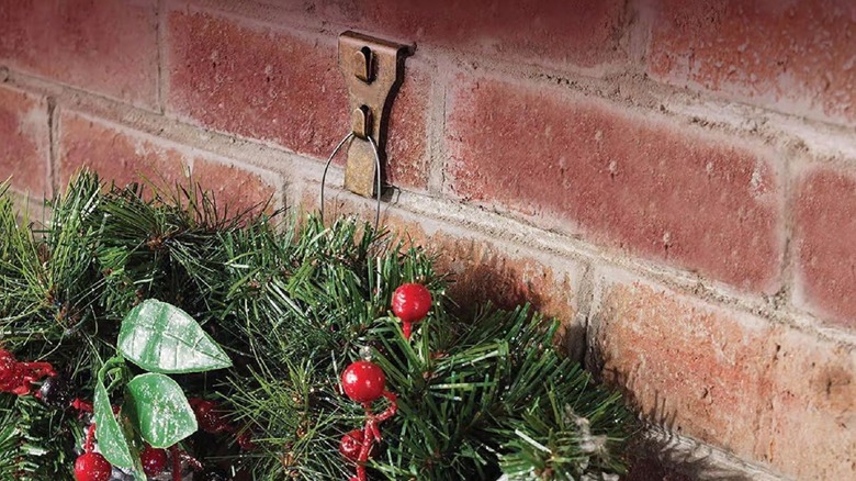 a brick clip holding up a seasonal wreath