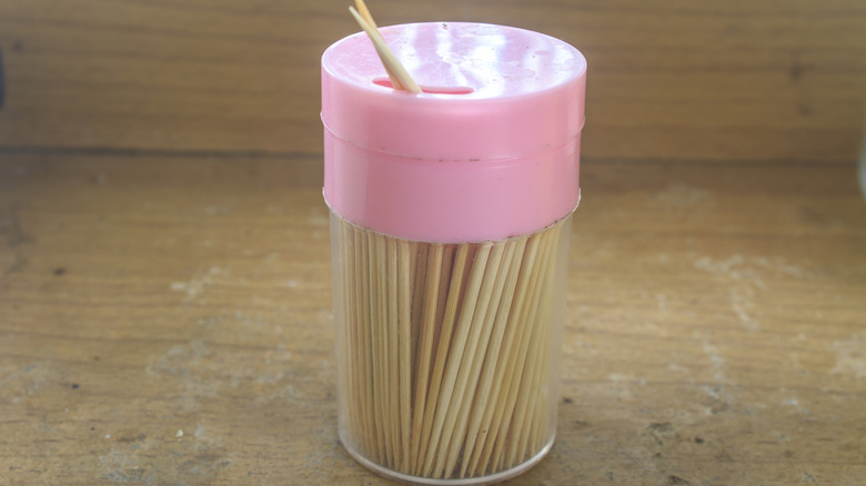 Toothpicks inside a clear spice jar with a small hole on top