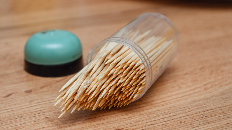 An open container with toothpicks inside