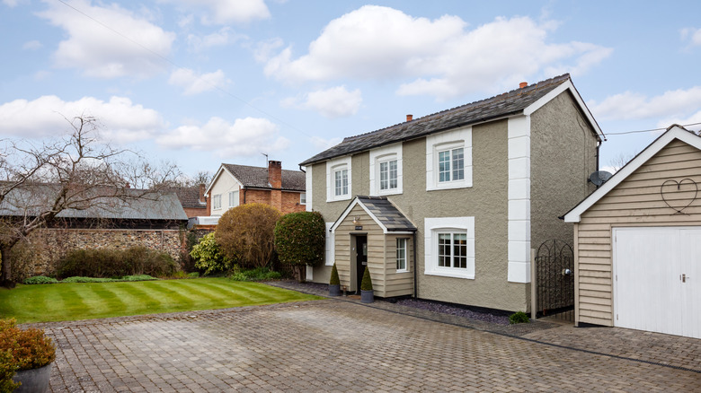 A home with a large driveway made from pavers.