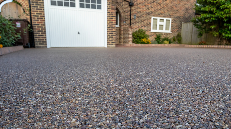 A resin-stone driveway in front of a house.