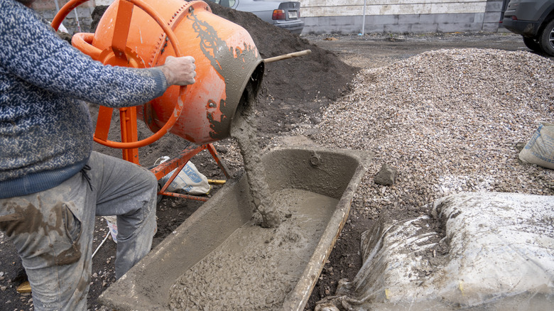 Pouring concrete from a mixer.