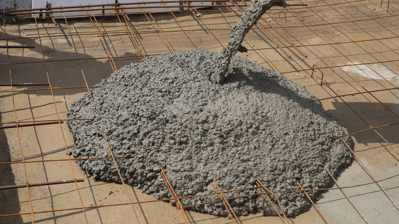 Concrete pouring over mesh reinforcement.