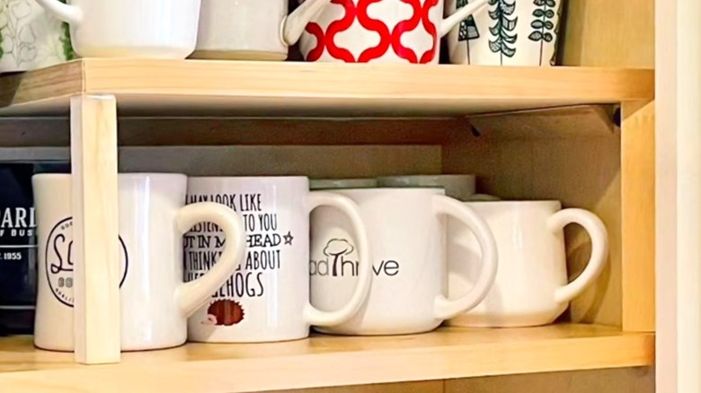 DIY shelf in cabinet holding coffee mugs