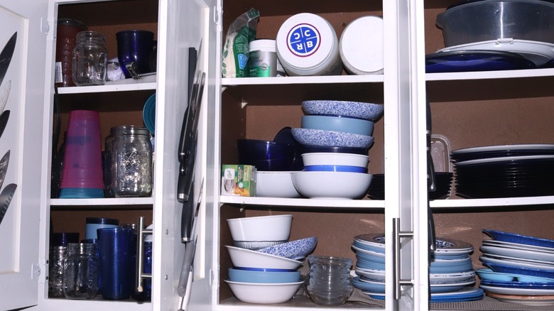A picture of a cluttered kitchen cabinet
