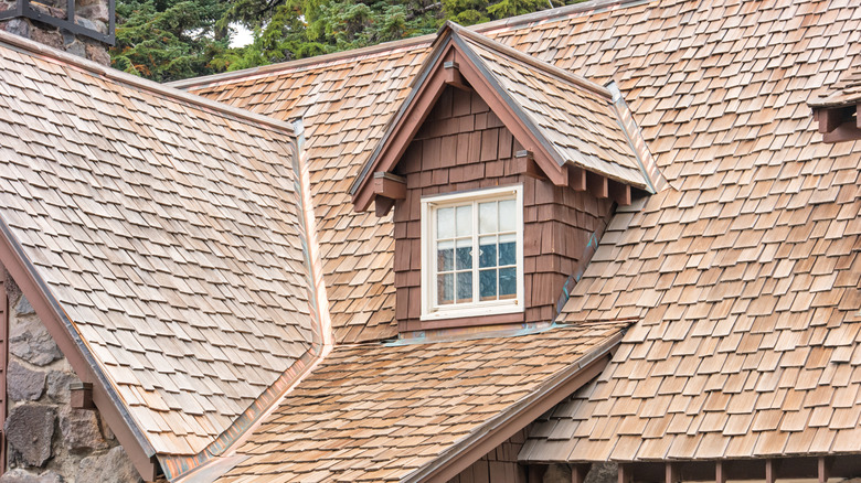 Cedar wood shingles on traditional old-fashioned home with wood and masonry siding