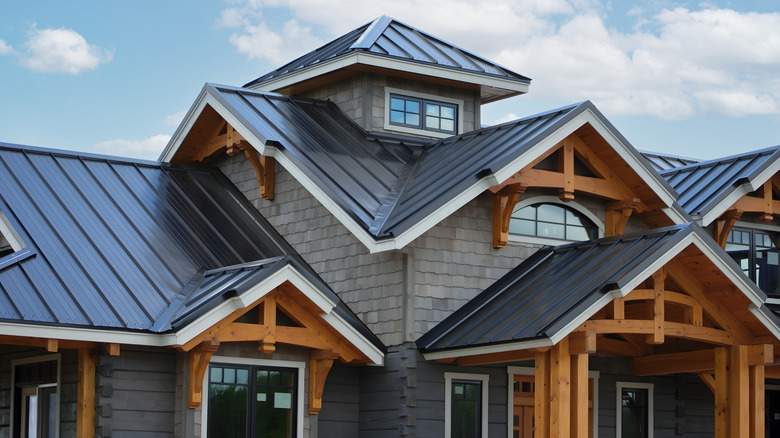 Modern mansion with wood accents and metal roof in daylight