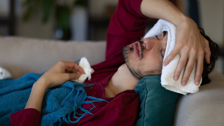 Someone sick using a towel