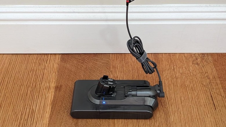 Customer review photo of Dyson v15 battery charging in wall on wood floor