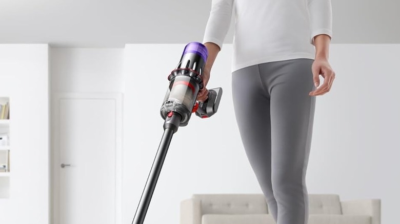 woman holding power trigger on Dyson digital slim cordless vacuum