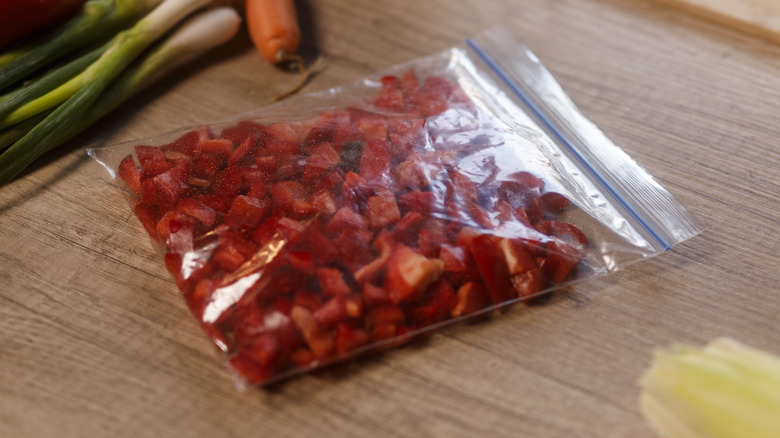 Plastic storage bag filled with chopped red peppers